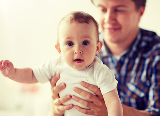 Image showing happy young father with little baby at home