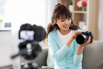 Image showing asian female blogger with camera recording video