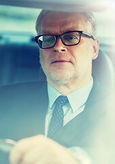 Image showing senior businessman driving car