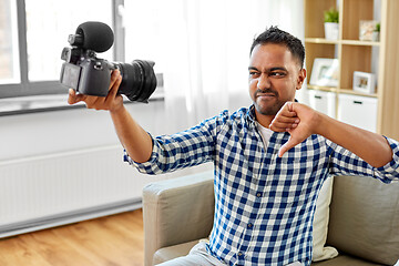 Image showing male video blogger with camera blogging at home