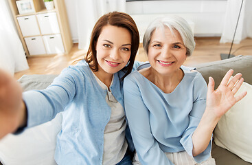 Image showing senior mother and adult daughter taking selfie