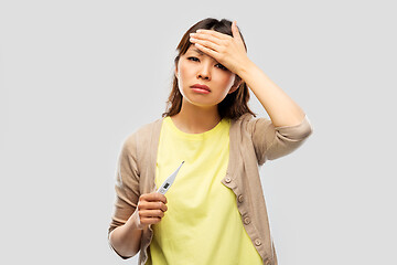 Image showing sick asian woman with thermometer having fever