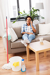 Image showing woman calling on smartphone after home cleaning