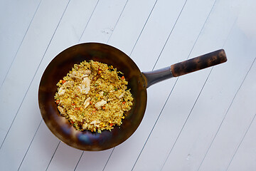 Image showing Delicious Thai dish in hot Wok. Fried chicken with rice and vegetables.