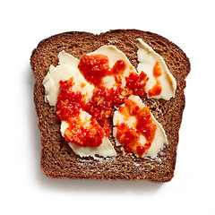 Image showing slice of rye bread with butter and chili