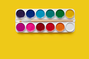 Image showing watercolor package on a yellow background