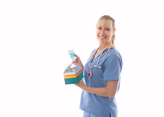 Image showing Smiling nurse holding a box of surgical medical masks or much ne