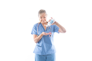 Image showing Nurse using or demonstrating hand sanitizer