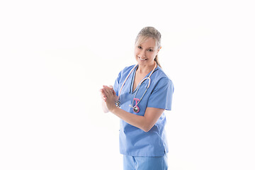 Image showing Friendly nurse using an alcohol hand sanitizer