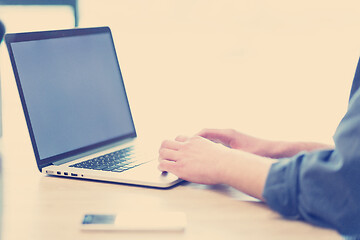 Image showing businessman working using a laptop in startup office