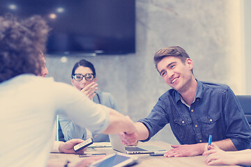 Image showing cloasing the deal in modern office interior