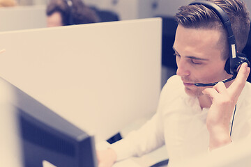 Image showing male call centre operator doing his job