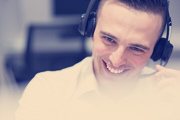 Image showing male call centre operator doing his job