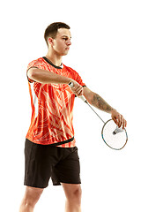 Image showing Young male badminton player over white background