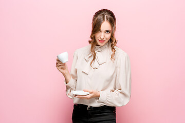 Image showing The serious frustrated young beautiful business woman on pink background