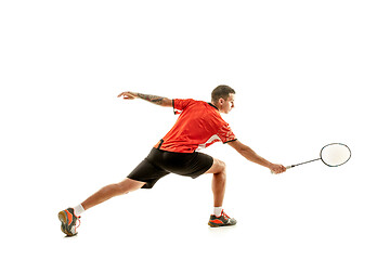 Image showing Young male badminton player over white background