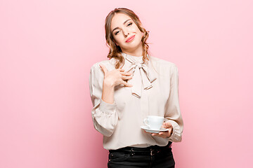 Image showing The serious frustrated young beautiful business woman on pink background