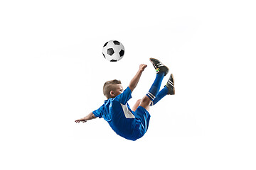 Image showing Young boy with soccer ball doing flying kick