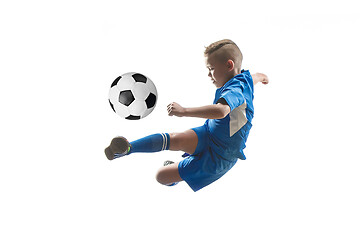 Image showing Young boy with soccer ball doing flying kick