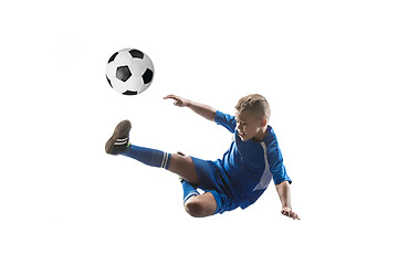 Image showing Young boy with soccer ball doing flying kick