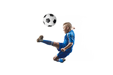 Image showing Young boy with soccer ball doing flying kick