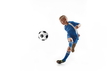 Image showing Young boy with soccer ball doing flying kick