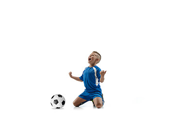 Image showing Young boy with soccer ball doing flying kick