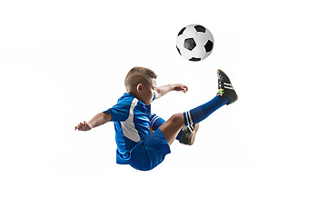 Image showing Young boy with soccer ball doing flying kick