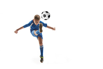 Image showing Young boy with soccer ball doing flying kick