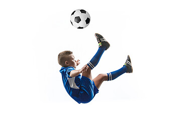 Image showing Young boy with soccer ball doing flying kick