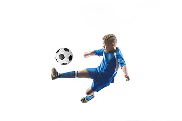 Image showing Young boy with soccer ball doing flying kick