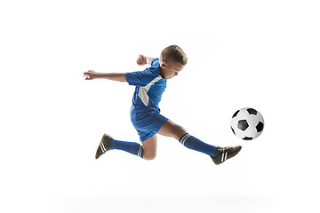 Image showing Young boy with soccer ball doing flying kick