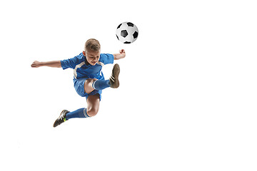 Image showing Young boy with soccer ball doing flying kick