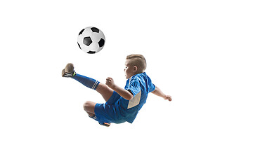 Image showing Young boy with soccer ball doing flying kick