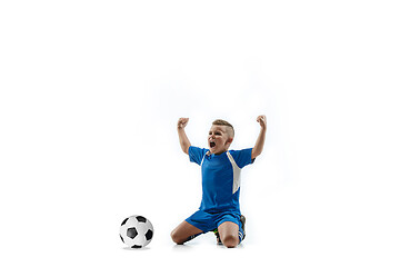 Image showing Young boy with soccer ball doing flying kick