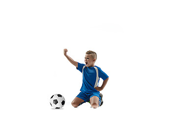 Image showing Young boy with soccer ball doing flying kick