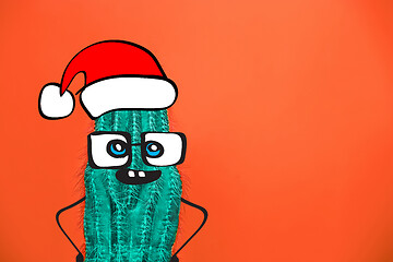 Image showing Cactus hipster man with santa hat. Tropical Christmas concept. Minimal fun art