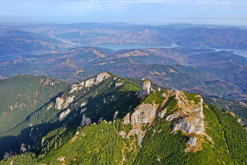 Image showing Drone view, mountain peak, forest and lake arround