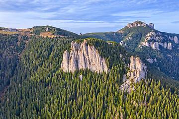 Image showing Rocks in sunset colors and evergreen forest