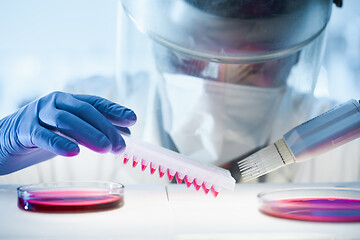 Image showing Scientist working in the corona virus vaccine development laboratory research with a highest degree of protection gear.