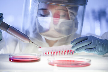 Image showing Female scientist working in the corona virus vaccine development laboratory research with a highest degree of protection gear.