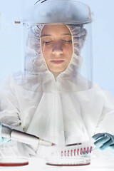 Image showing Female scientist working in the corona virus vaccine development laboratory research with a highest degree of protection gear.