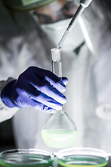 Image showing Scientist working in the corona virus vaccine development laboratory research with a highest degree of protection gear.