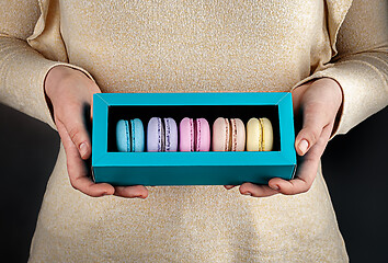 Image showing Girl hold one gift box with macaroons