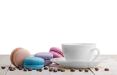 Image showing Macaroons with coffee on wooden table
