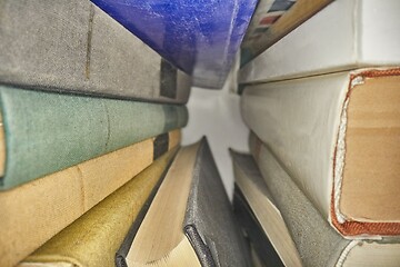 Image showing Piled up books macro view between them