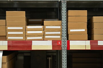 Image showing Warehouse stocked with boxes in stacks