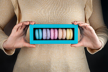 Image showing Girl hold colorful macaroons in gift box