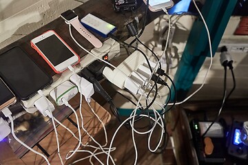 Image showing Charging phones and other devices in a mess