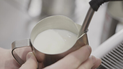 Image showing Barista whipped milk in the coffee machine in the foam for the preparation of the drink. Slow motion, Full HD video, 240fps, 1080p.